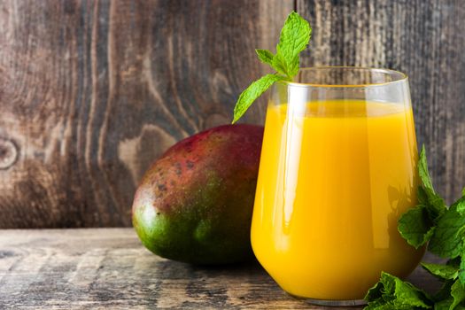 Mango Lassi dessert. Traditional Indian drink on wooden table. Copyspace