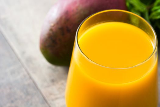 Mango Lassi dessert. Traditional Indian drink on wooden table. Copyspace