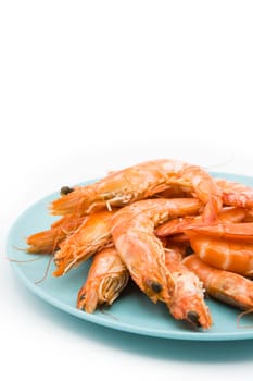 Grilled shrimps on blue plate isolated on white background