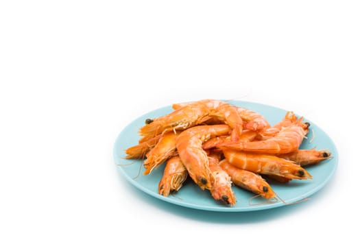 Grilled shrimps on blue plate isolated on white background