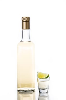 Mexican Gold tequila bottle and glass isolated on white background