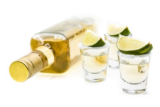 Mexican Gold tequila with lime and salt isolated on white background
