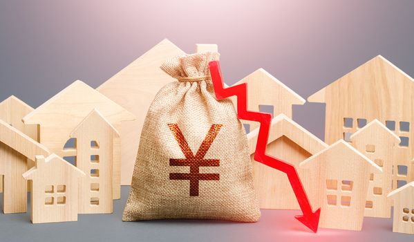 City residential buildings and Yen Yuan money bag with a red down arrow. Low cost of real estate. Low demand for home buying. Lower mortgage interest rates. Falling prices for rental apartments.