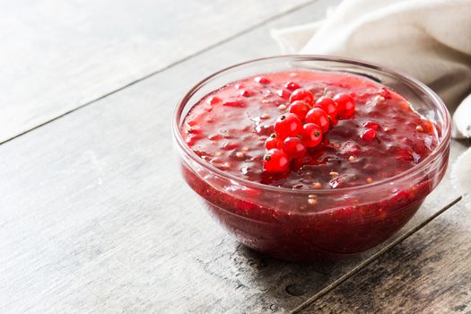 Cranberry sauce in bowl for Thanksgiving dinner on wooden table