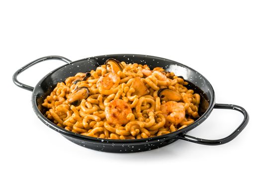 Traditional Spanish fideua. Noodle paella isolated on white background.