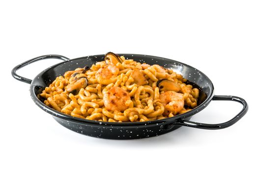 Traditional Spanish fideua. Noodle paella isolated on white background.