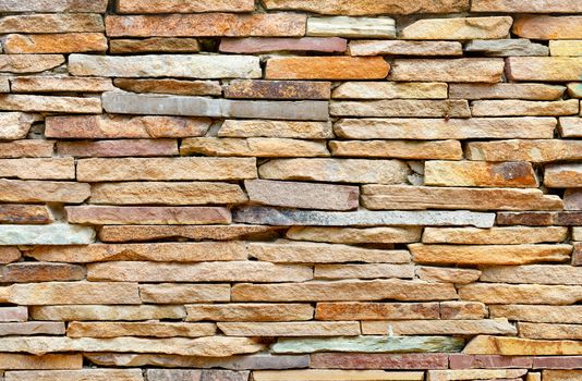 The texture and background of the stone wall are made of pieces of old flat gold sandstone in light blur.