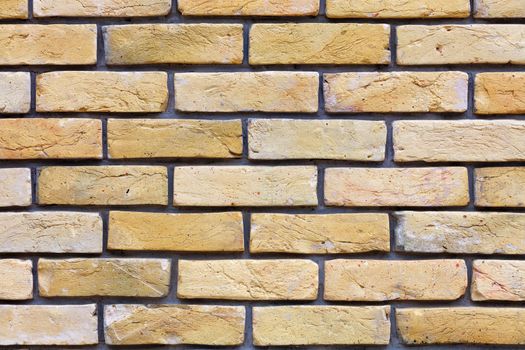 Wall of old vintage brick, texture of beige brick wall, protruding brick, neat masonry, close-up.