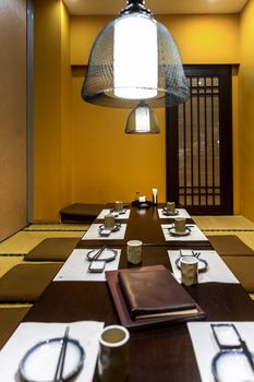 Large table in japanese restaurant with yellow interior