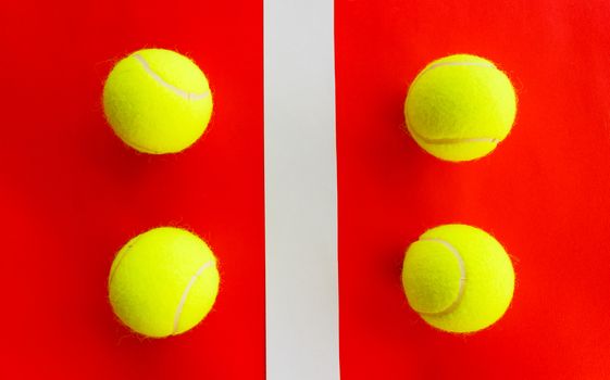 four tennis balls divided by a field line they represent a  double encounter