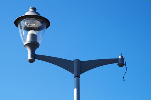 street lamp with one intact and one broken lamp close up