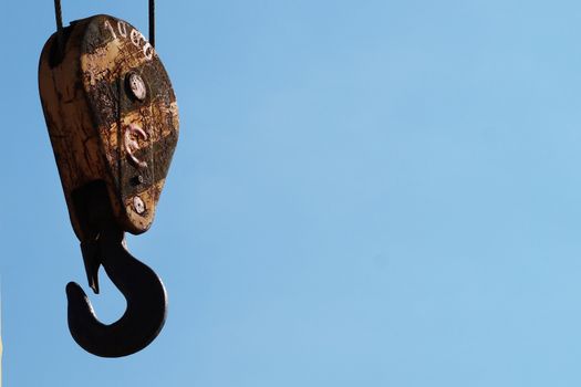 hook from the hoisting winch against the sky close up, copy space