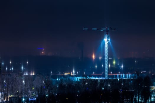 night winter cityscape with light pillars atmospheric phenomenon.