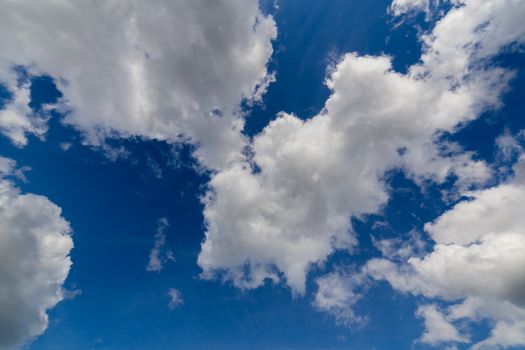 Regular spring clouds on blue sky at daylight in continental europe. Upward shot with wide angle lens without any filter.