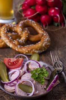 bavarian sausage salad on dark wood