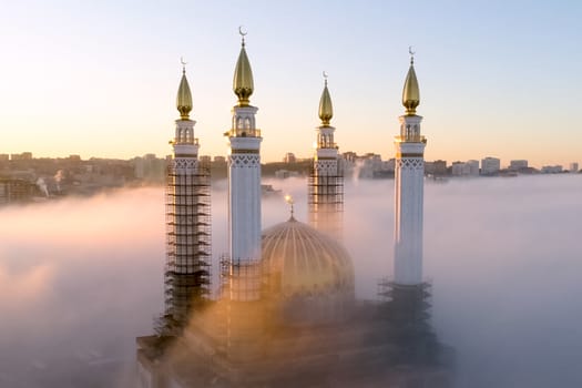 The Kazan Mosque is shrouded in mist at dawn. View from above.