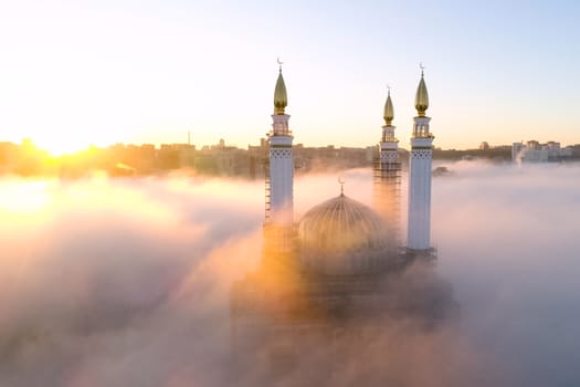 The Kazan Mosque is shrouded in mist at dawn. View from above.