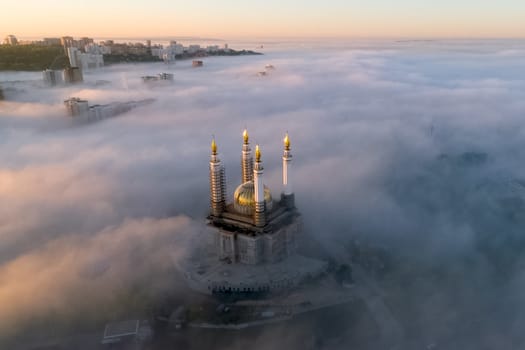 The Kazan Mosque is shrouded in mist at dawn. View from above.