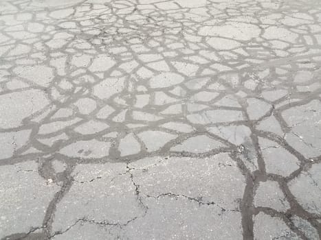 lines in cracked and damaged or worn or weathered black asphalt