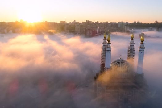 The Kazan Mosque is shrouded in mist at dawn. View from above.