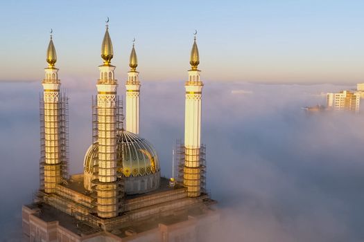 The Kazan Mosque is shrouded in mist at dawn. View from above.