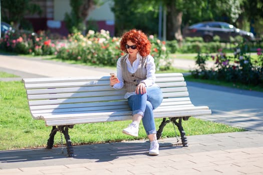 The use of modern technologies in everyday life. Nowhere without a phone. Summer walk and talking on the phone