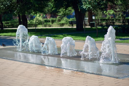 Dry fountain in the summer city park. A fountain without a bowl. Small fountain.