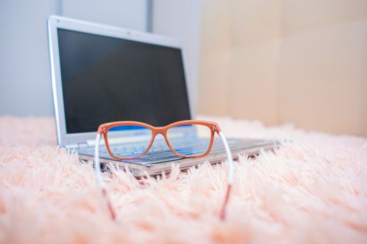 View of a laptop through special glasses for working on a computer. Eye protection from the influence of the monitor screen