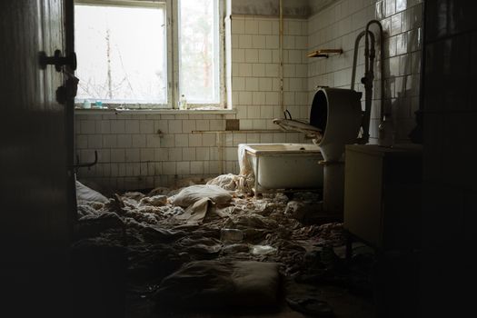 Old laundry room of abandoned hospital low angle shot