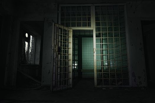 Old abandoned prison cell in the dark closeup