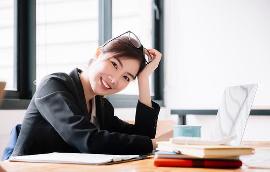Portrait Of Attractive Asian Businesswoman Smiling in office.