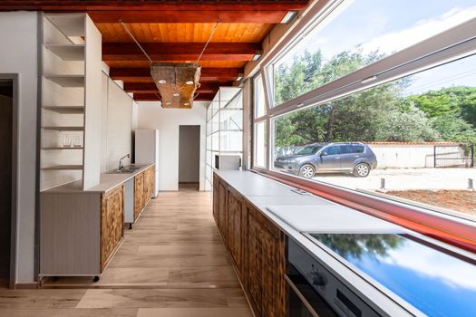 Kitchen area of luxury apartment with large windows