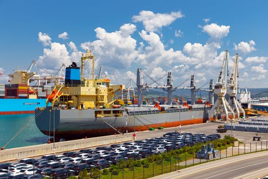 Large industrial port with many cranes and cargo containers