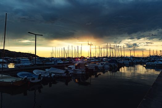 Sunset at boat marina with dramatic sky anle shot