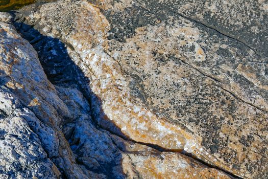 Rough stone surface as background texture closeup photo