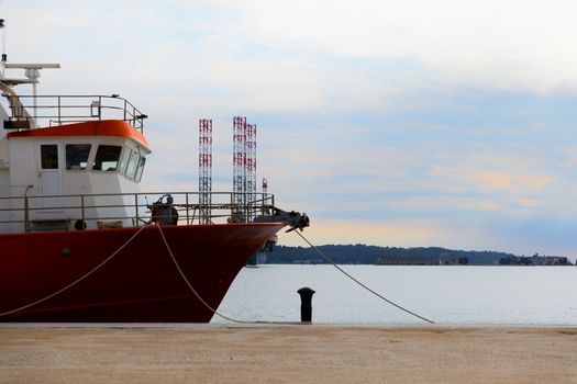 Old fishing boat anchored in the port closeup photo