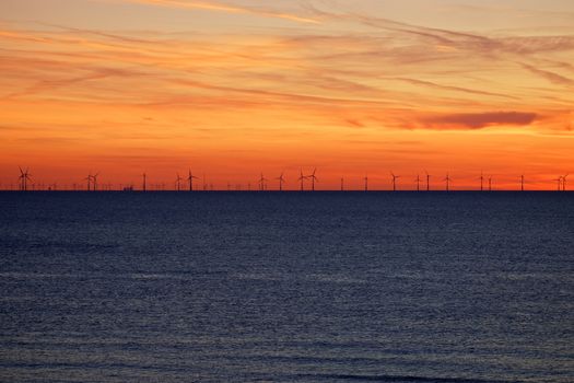 Windfarm on the sea at sunset closeup footage