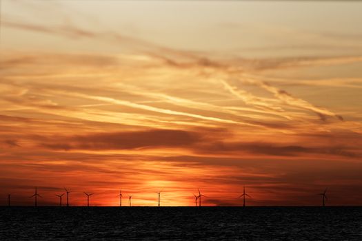 Windfarm on the sea at sunset closeup