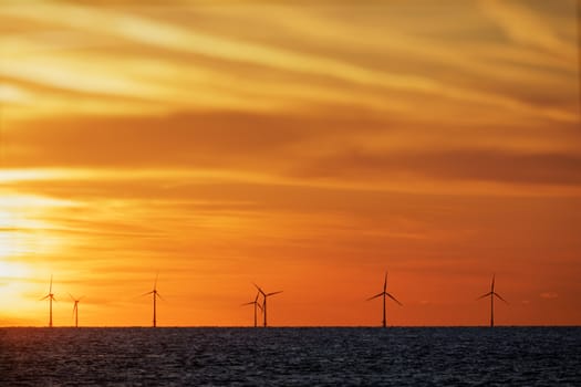 Windfarm on the sea at sunset closeup