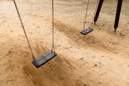 Some swings in the schoolyard close up photo