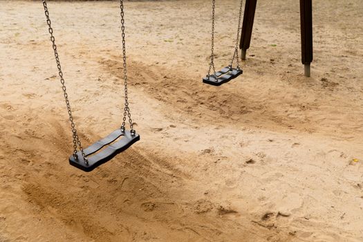 Some swings in the schoolyard close up photo