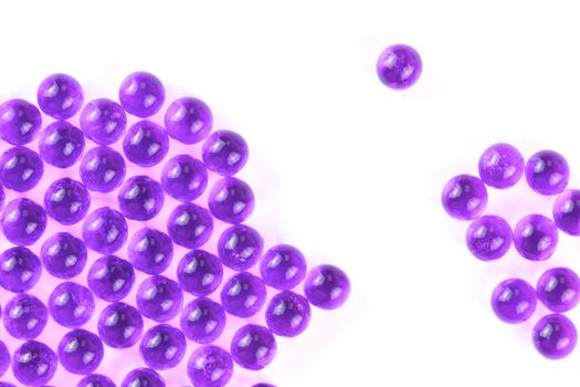 proton purple spherical ball capsules with selective focus isolated on white background.