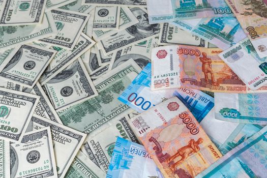 russian rubl and us dollar banknotes close-up with selective focus and blur