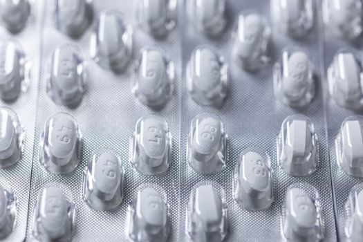 white tablets in blister closeup with selective focus.