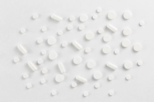 pills flat background, tablets spreaded on a white - top-down view.