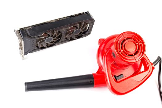 Electrical air blower and dusty pc video card isolated on white background.