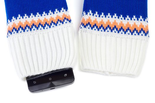 cellphone sticking out from knitted fabric like sweater or mittens.