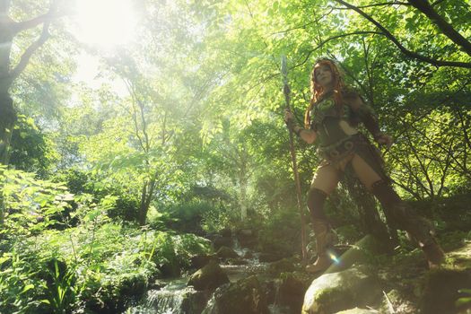 Elven warrior woman in the deep forest closeup photo