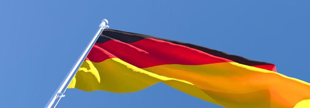 3D rendering of the national flag of Germany waving in the wind against a blue sky