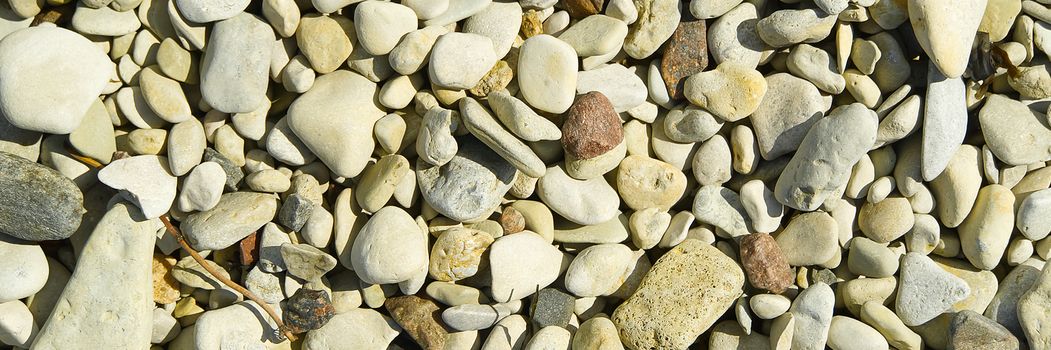 Baltick Sea beach. Natural small pebbles on the rocky seashore, panorama. can be usedas texture or backround